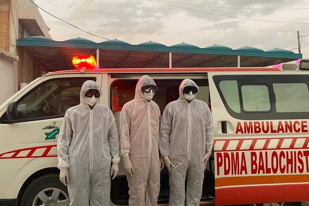 Pakistani medical staff stand at the Pakistan-Iran border on Tuesday. The border was closed due to the coronavirus outbreak in neighbouring Iran. Photo: AP