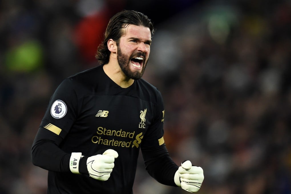 Liverpool goalkeeper Alisson Becker celebrates after his team score the opening goal in the English Premier League win over West Ham. Photo: EPA