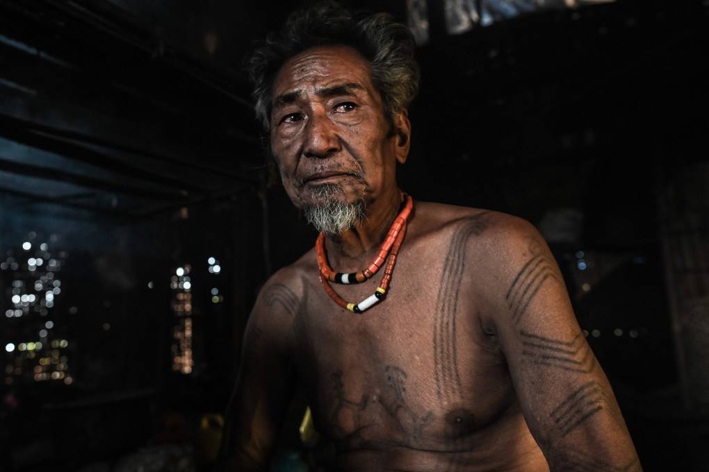 Ngon Pok, 80, said he was around six when he got his first tattoo. ‘People had to catch me and hold me down.’ Photo: AFP