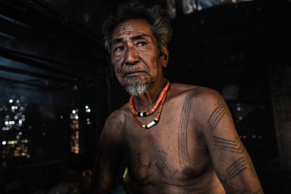 Ngon Pok, 80, said he was around six when he got his first tattoo. ‘People had to catch me and hold me down.’ Photo: AFP