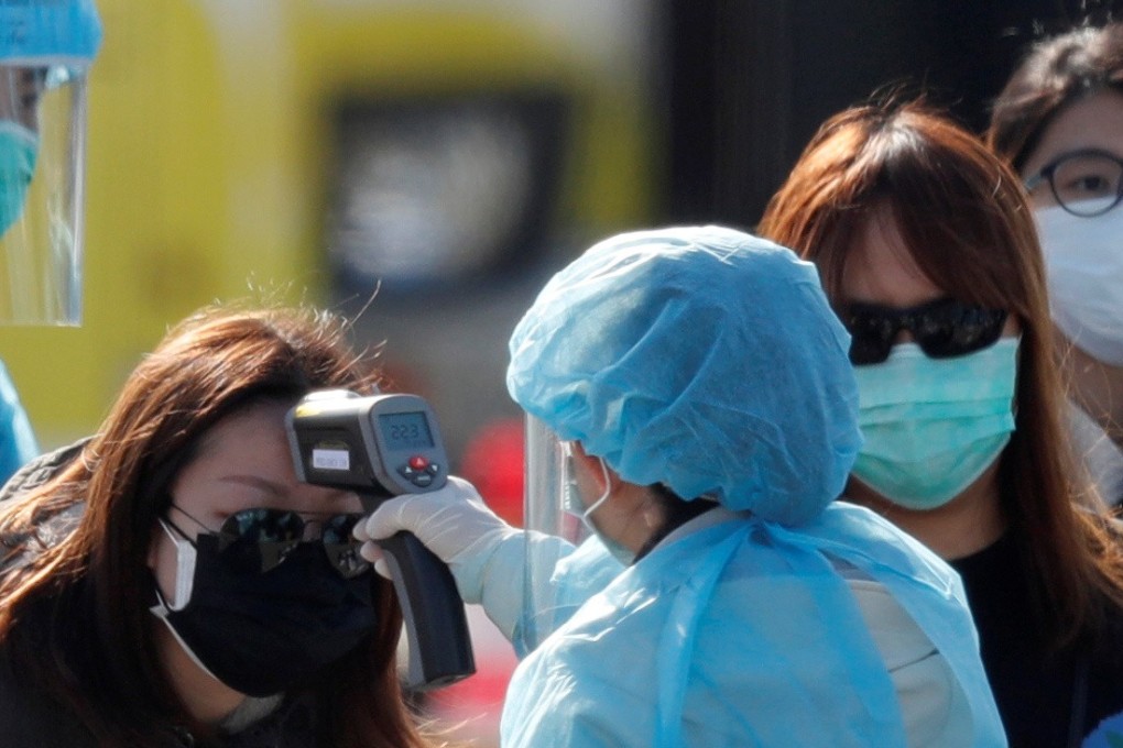 A passenger has her body temperature taken upon leaving the coronavirus-hit cruise ship Diamond Princess in Yokohama. Photo: Reuters