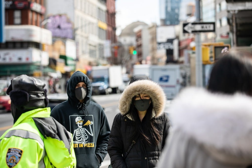 Pedestrians wear masks while walking in New York on February 27. Photo: Bloomberg