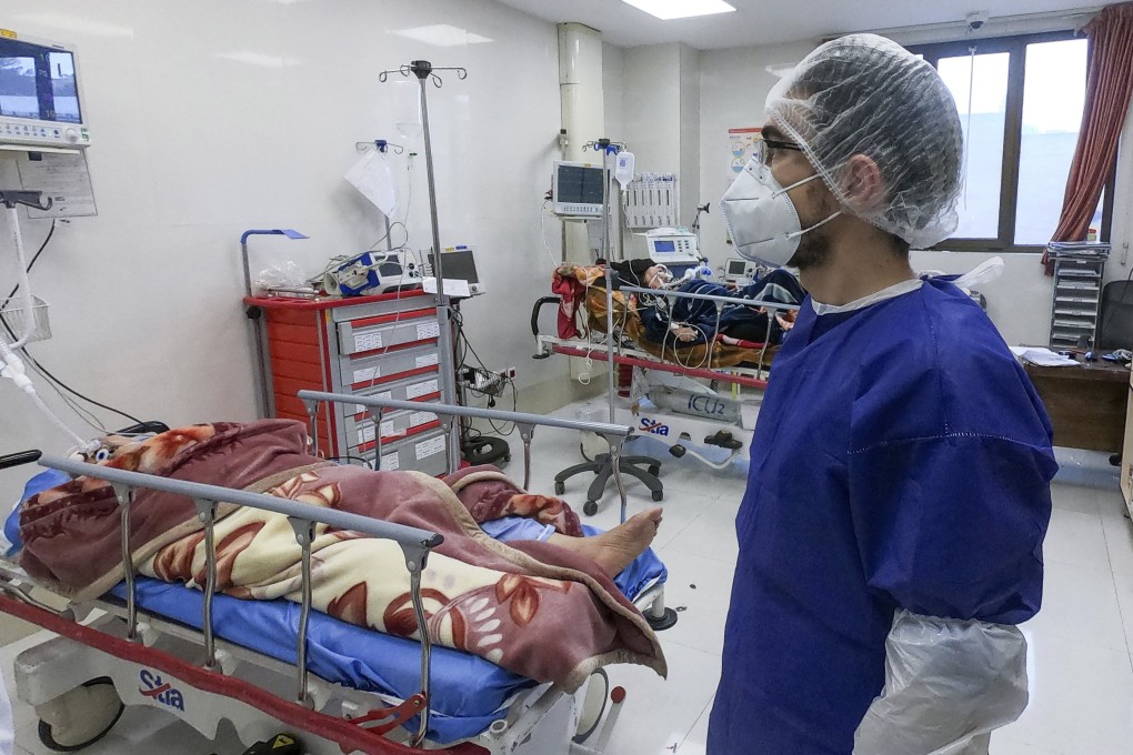 A nurse cares for patients in a ward set aside for people infected with the coronavirus, at Forqani Hospital in Qom. Photo: Mizan News Agency via AP
