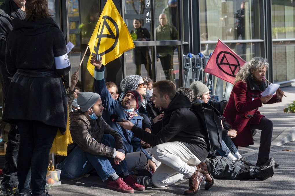 Climate change activists from the Extinction Rebellion movement block an entrance to a terminal at Geneva Airport, Switzerland, in November. Photo: EPA-EFE