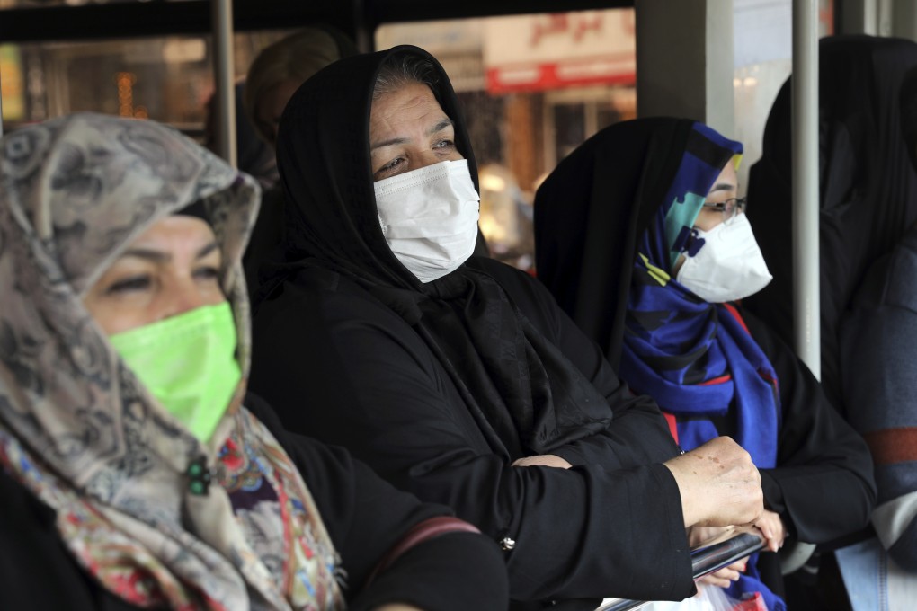Commuters wear masks on a public bus in Tehran. Photo: AP