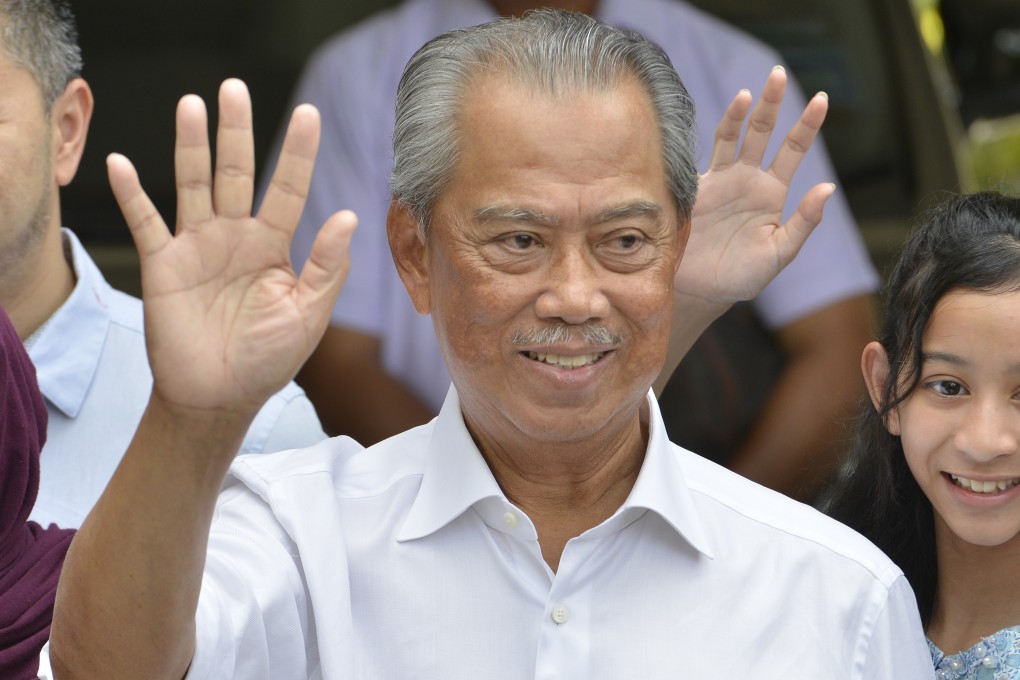 Muhyiddin Yassin waves to media after outside his house in Kuala Lumpur after he being appointed as the new Malaysian prime minister on Saturday. Photo: AP