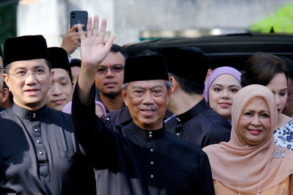 Muhyiddin Yassin, Malaysia's prime minister-designate, centre, waves to members of the media at his home before leaving for a swearing-in ceremony at the National Palace in Kuala Lumpur, Malaysia. Photo: Bloomberg
