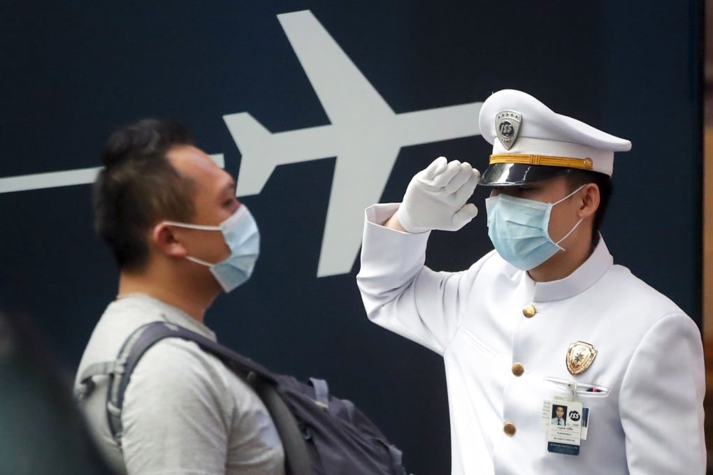 A greeter at a department store wearing a protective mask welcomes visitors in Bangkok, Thailand. Photo: EPA