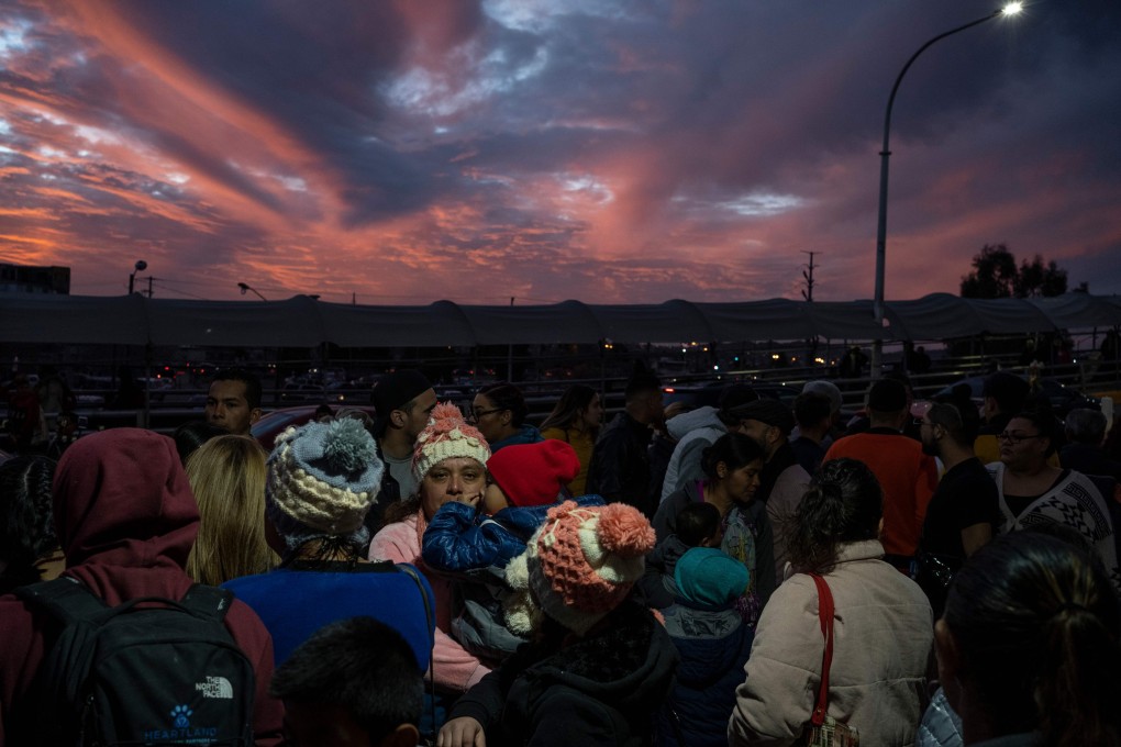Migrants part of the ‘Remain in Mexico’ policy wait at the entrance to the Paso del Norte International Bridge. Photo: AFP