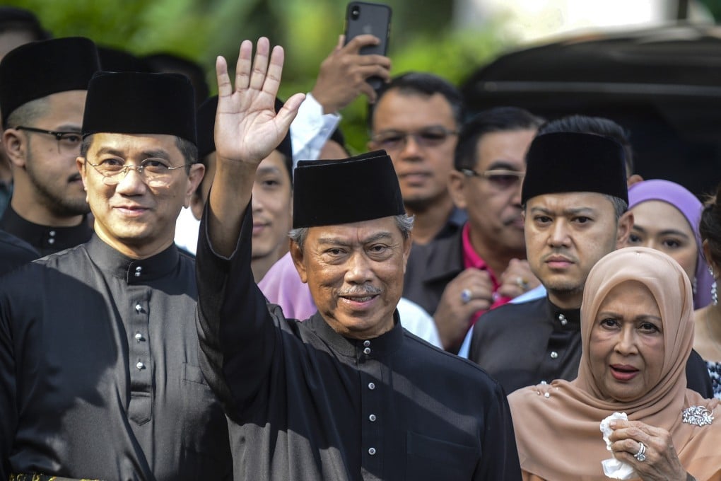 Malaysia's new Prime Minister Muhyiddin Yassin waving outside his residence before his inauguration on Sunday. Photo: Handout