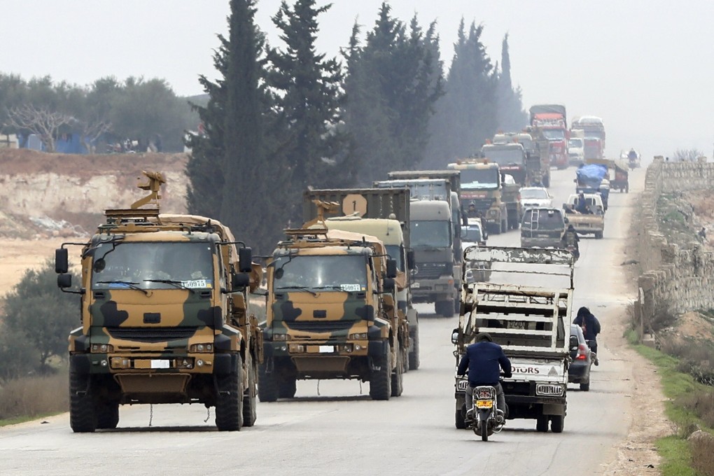 A Turkish military convoy moves in the east of Idlib, Syria on Friday. Photo: AP