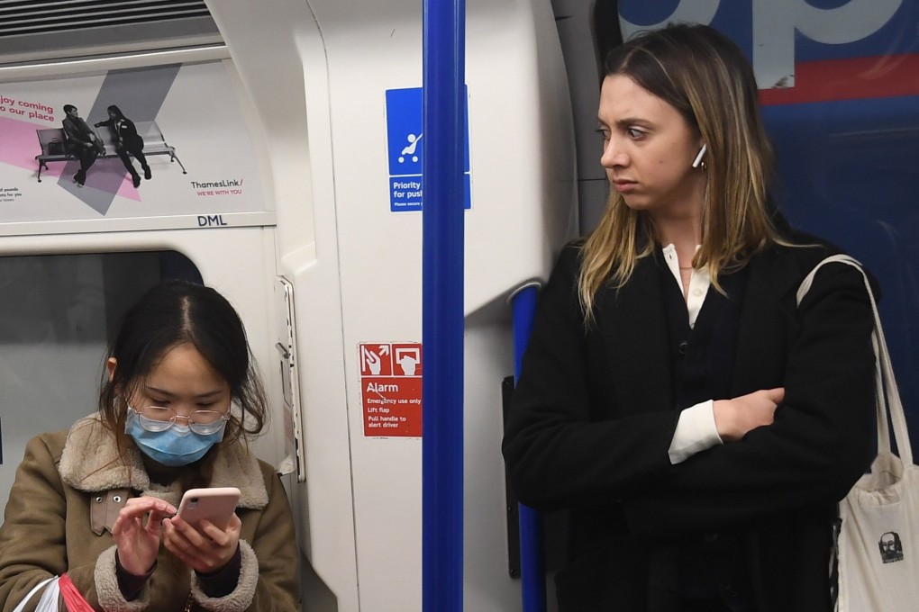 A woman wears a face mask on the London Underground. Prime Minister Boris Johnson said the disease was likely to ‘spread a bit more’ in the UK. Photo: EPA