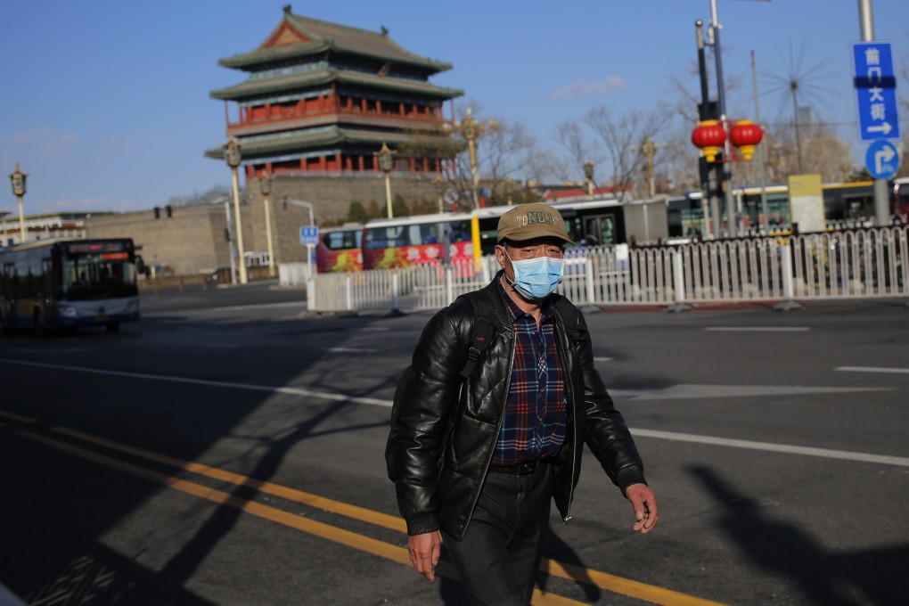 A man wearing a protective mask walks on an unusually quiet Beijing street due to the coronavirus on March 1, 2020. Photo: EPA-EFE