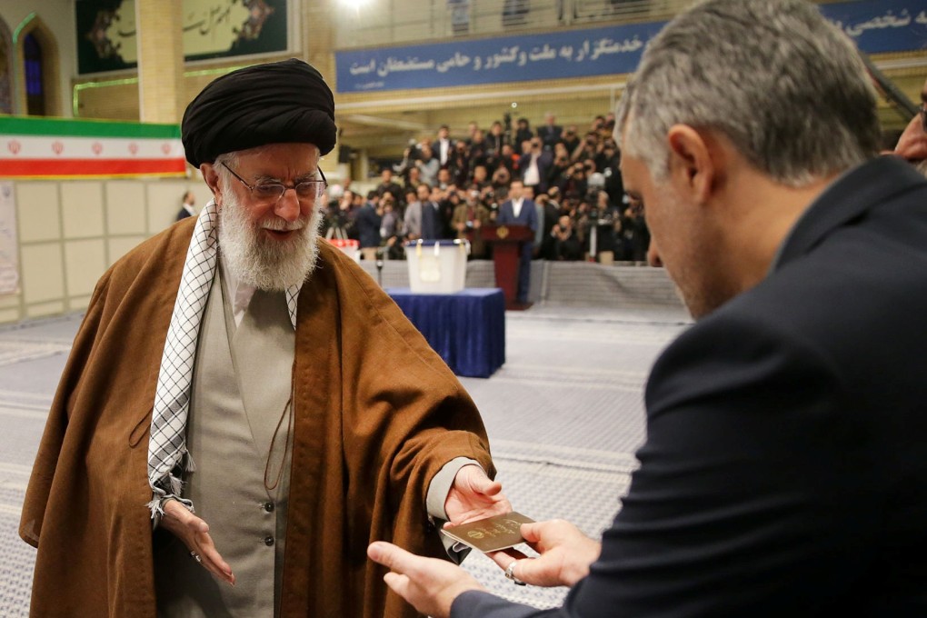 Iran's Supreme Leader Ayatollah Ali Khamenei cast his vote at a polling station last month. One of his advisers has died after falling ill from the new coronavirus. Photo: Reuters