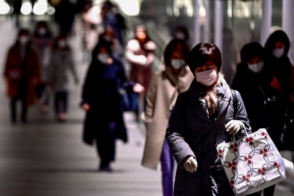 People wearing face masks pictured in Tokyo’s upmarket shopping, dining and entertainment district of Ginza on Monday. Photo: AFP