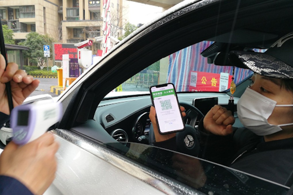 A driver showing his green health code to enter an apartment complex in China. Photo: Handout