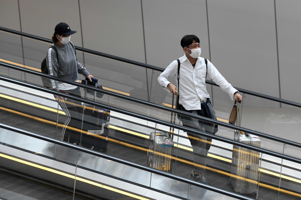 Travellers wearing protective face masks amid fears about the spread of the coronavirus pictured at Changi International Airport in Singapore. Photo: AFP