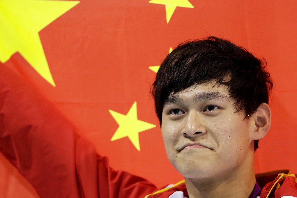 Sun Yang holds his national flag after winning the 2012 Olympic gold medal in the men’s 1500-metre freestyle in London. Photo: AP