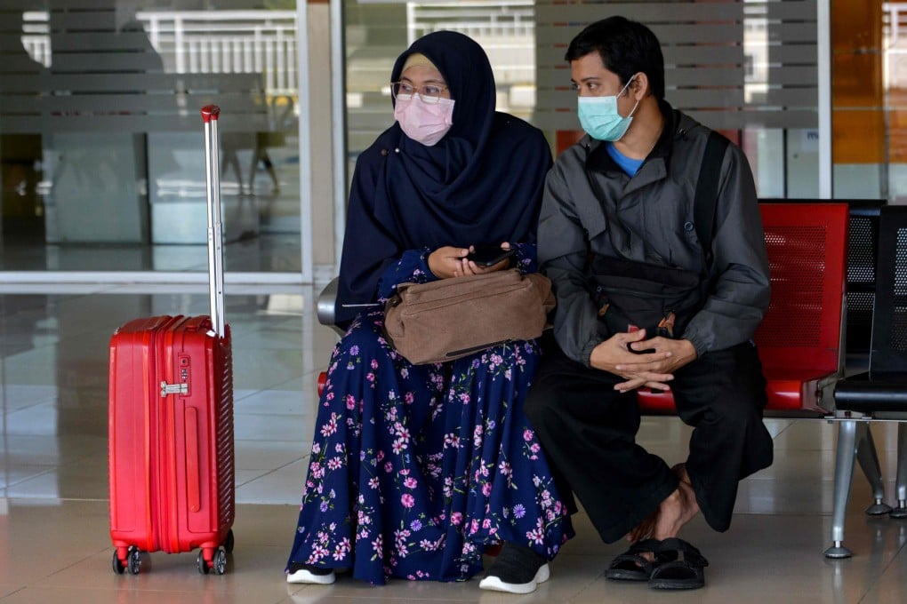 An Indonesian woman and man are pictured at an airport in Aceh Besar. Photo: AFP