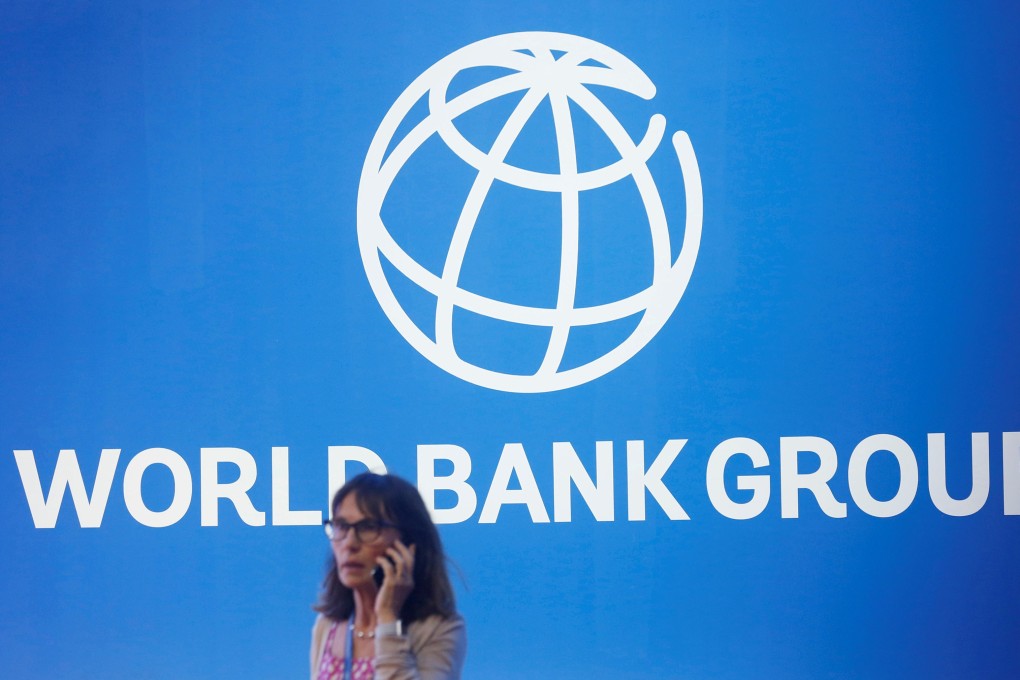 A participant stands near a World Bank logo at the IMF-World Bank Annual Meeting in Bali, Indonesia, in October 2018. Photo: Reuters