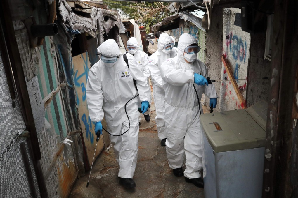 South Korean soldiers wearing protective gear spray disinfectant in Seoul as part of preventive measures against the coronavirus. Photo: AFP