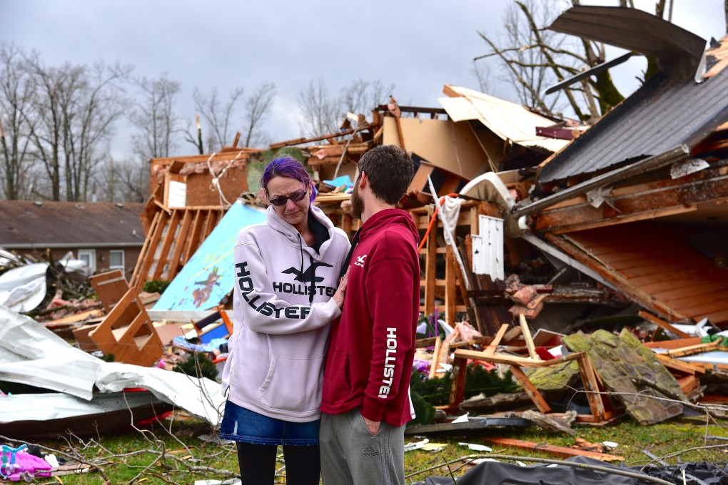 Deanna and Tony Speck, of Cookeville, Tennessee console one another on the front lawn of what's left of Deanna's parent's house. Photo: AP