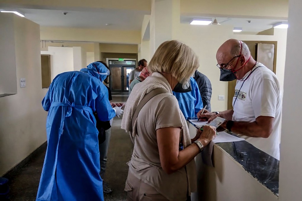 Italian tourists fill up forms after being put in preventive isolation at a quarantine facility in Chhawla in New Delhi. Photo: Agence France-Presse