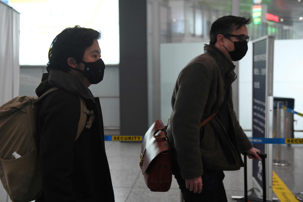 Wall Street Journal reporters Philip Wen (left) and Josh Chin leave China via Beijing Capital Airport on February 24, after the row over the newspaper’s “Sick Man of Asia” headline. Photo: AFP