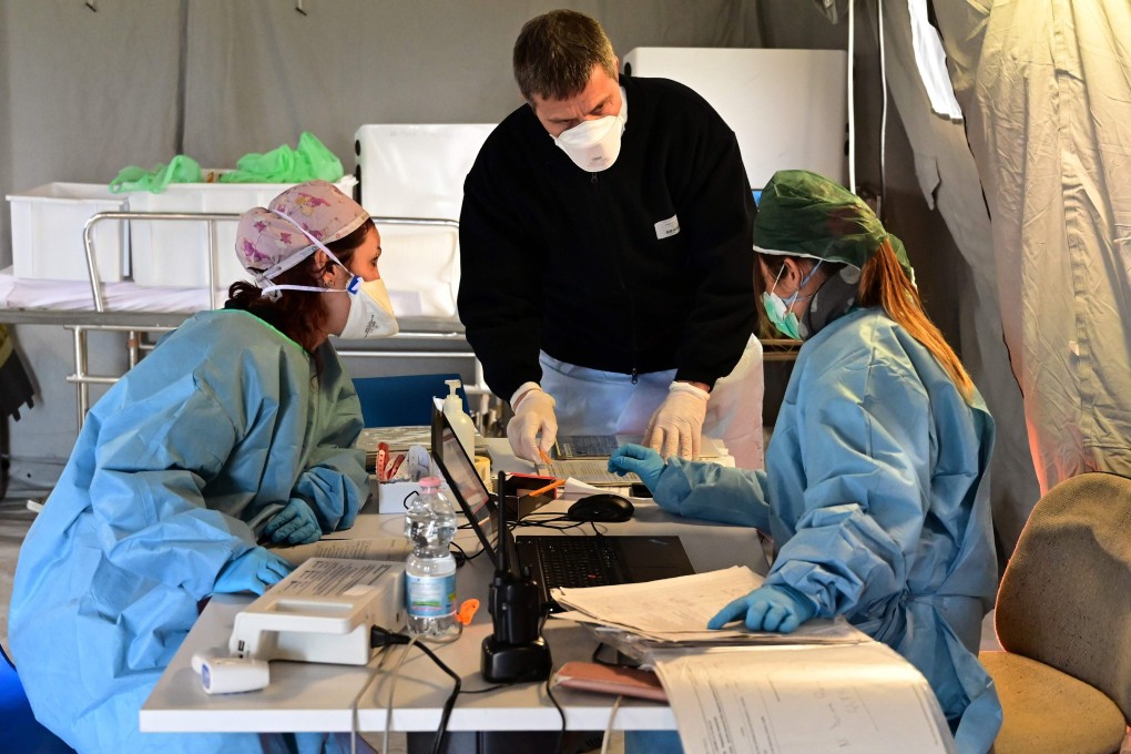 Health workers at a pre-triage medical tent located in front of the Cremona hospital, in Cremona, northern Italy. Photo: AFP