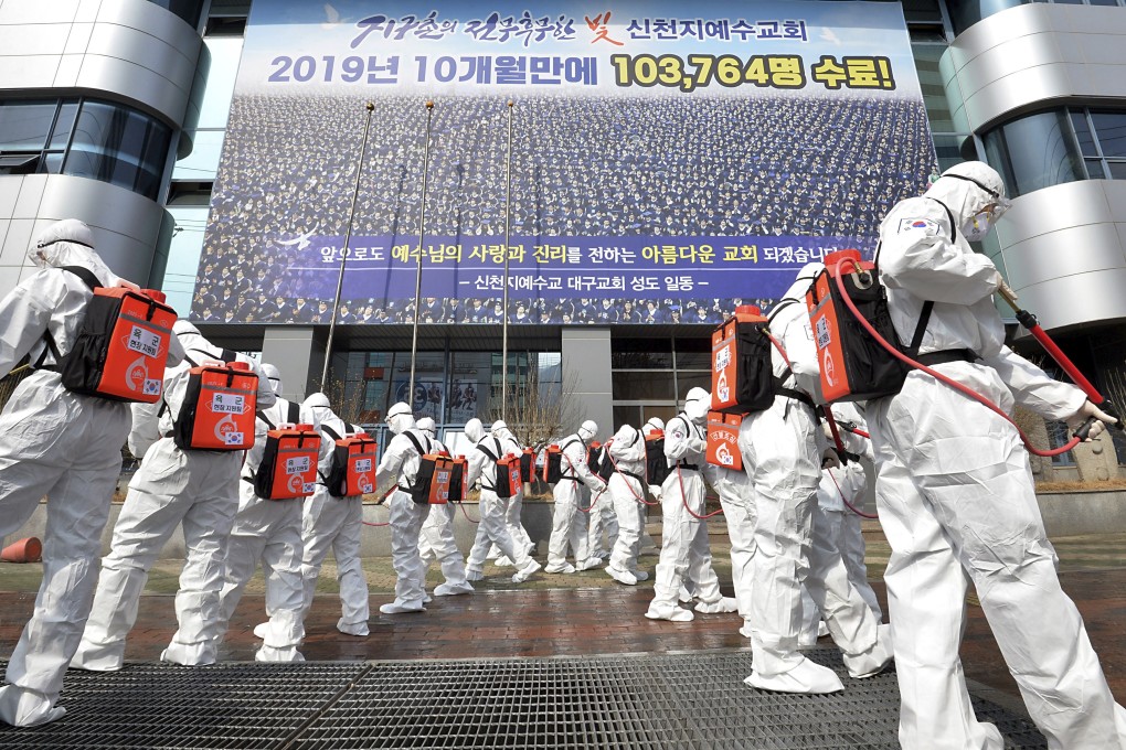 Soldiers in protective suits disinfect the area outside a Shincheonji church in Daegu, South Korea, on March 1, as Covid-19 cases outside China surge. Photo: AP