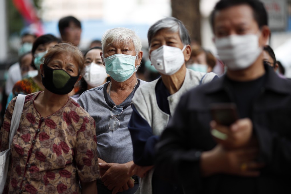 People queue up to buy face masks outside a pharmacy in in Bangkok, Thailand. Photo: EPA-EFE