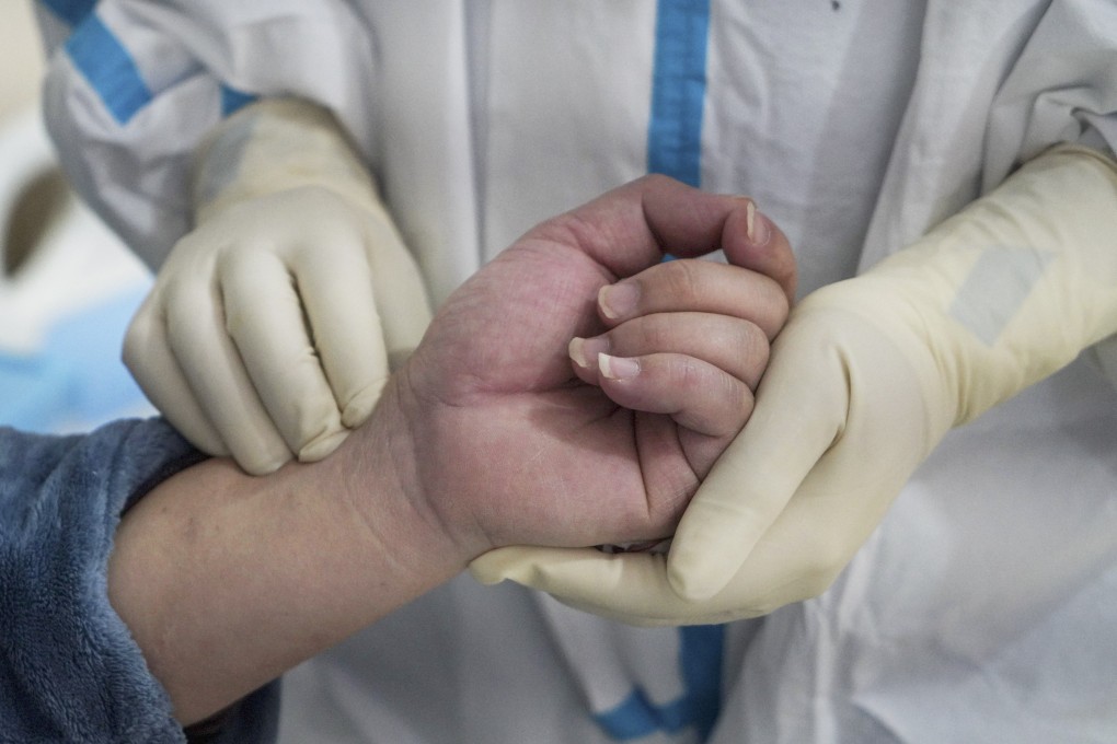 A medical worker checks a coronavirus patient’s pulse at the Affiliated Hospital of Jiangxi Traditional Chinese Medicine University in east China's Jiangxi province. Photo: Xinhua