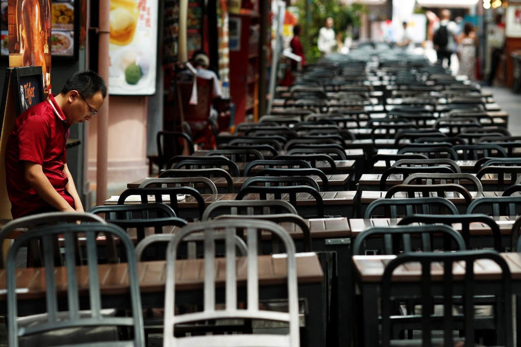 A restaurant worker waits for customers at a largely empty Chinatown on February 21, 2020. Photo: Reuters