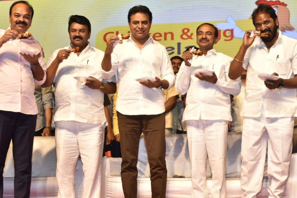 Lawmakers and celebrities eat chicken drumsticks on stage to encourage people to consume the meat, amid rumours that coronavirus can be spread by chicken. Photo: Poultry Voice