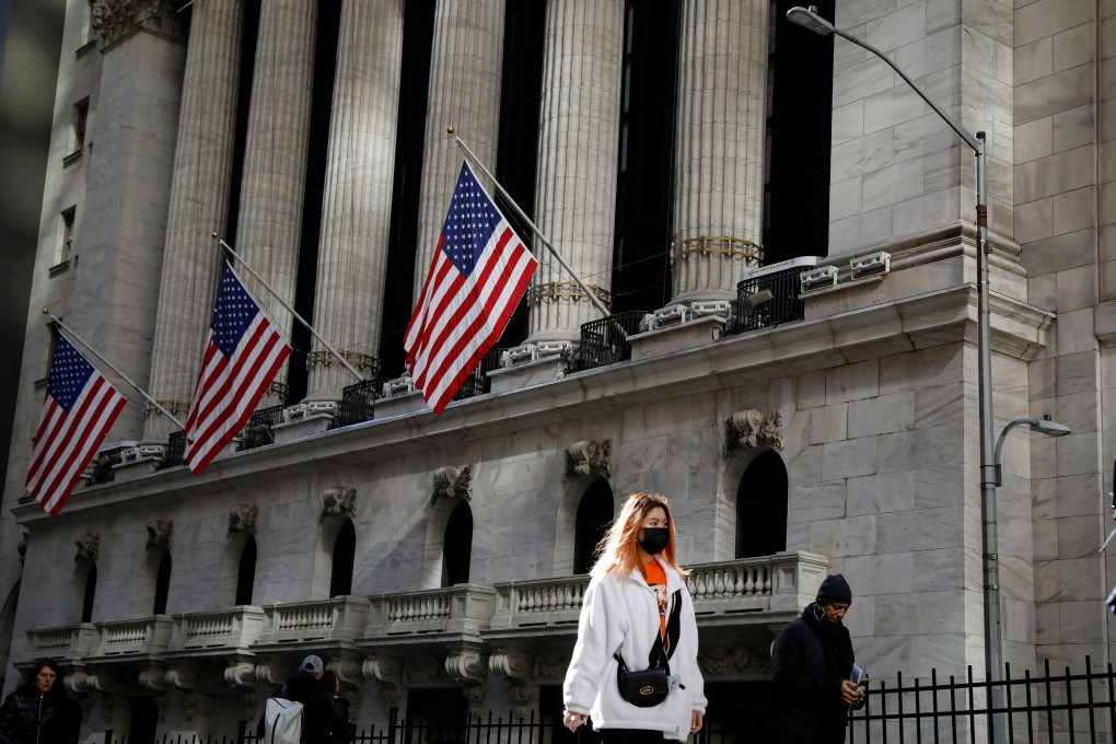 In an uncommon sight in America, a woman wears a mask near the New York Stock Exchange in New York on March 4. Photo: Reuters