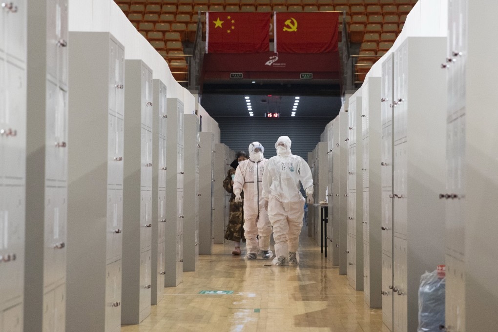 Medical workers carry out checks on coronavirus patients at a makeshift hospital in Wuhan. Photo: EPA-EFE
