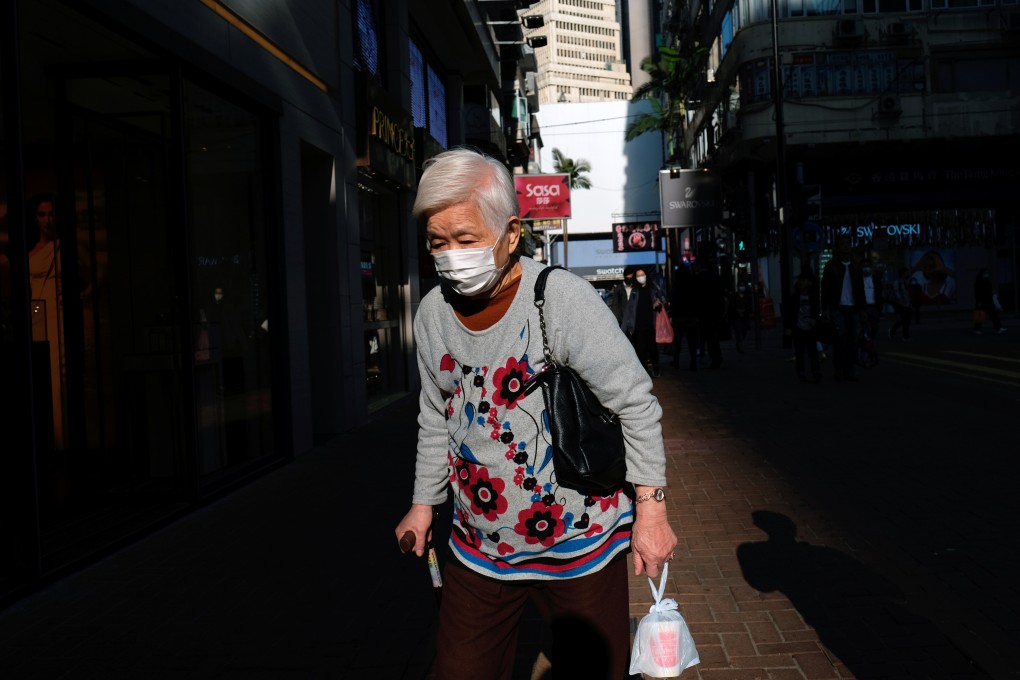 An elderly woman wears a protective mask as she walks through downtown Hong Kong amid the Covid-19 outbreak. Photo: Reuters