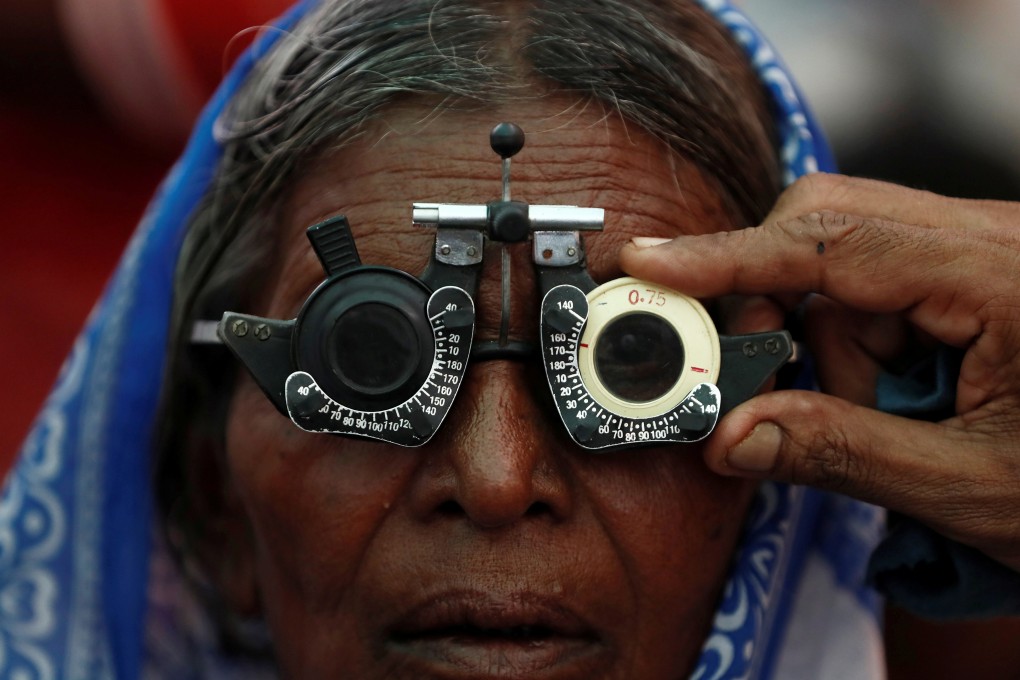 An elderly woman gets her eyes tested for free in Mumbai, India. Photo: Reuters
