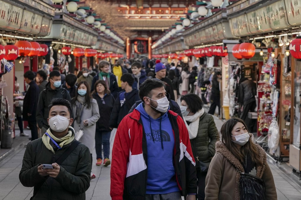 Tourists seen wearing masks at Asakusa district, downtown of Tokyo on March 5, 2020. Photo: EPA-EFE