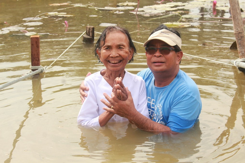 Former Khmer Rouge official Im Chaem is baptised by pastor Christopher LaPel, in Cambodia. Photo: Red Door News