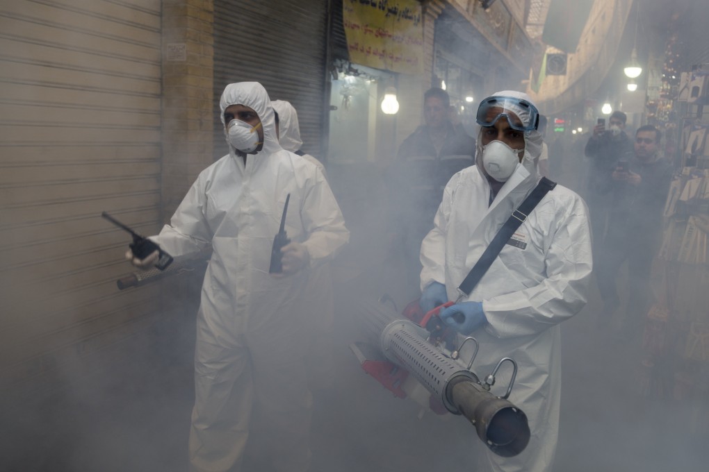 Workers in protective suits disinfect a market in Tehran on March 6, 2020. Photo: dpa