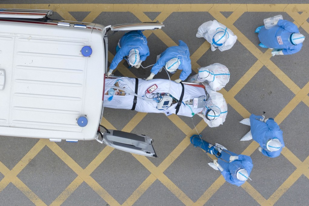 Medical workers receive a Covid-19 patient at a hospital in Wuhan where the new coronavirus outbreak began. Photo: Xinhua