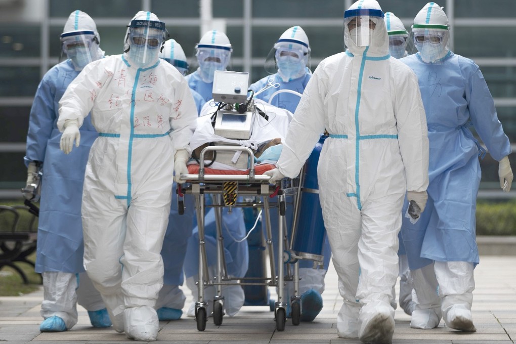 Medical workers transport a Covid-19 patient at a hospital in Wuhan, Hubei province. Photo: Xinhua
