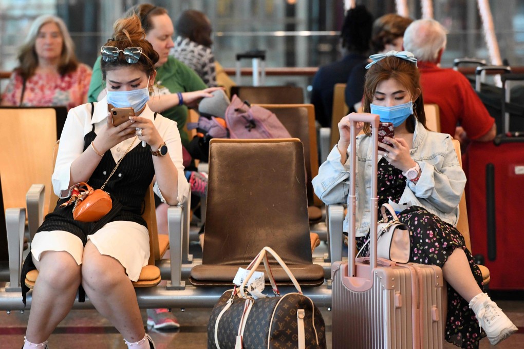 Travellers wearing protective masks at Changi International Airport in Singapore. Photo: AFP