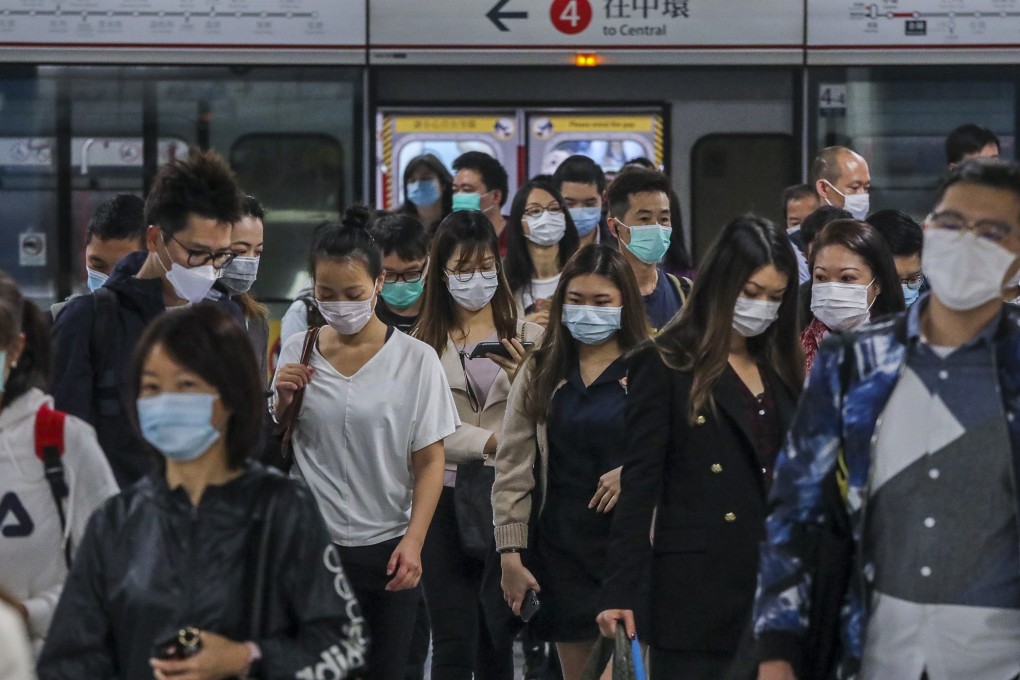 Commuters in masks at Admiralty station in Hong Kong. An expert says that while mainland China’s situation is stabilising, the contagion has spread worldwide. Photo: Felix Wong
