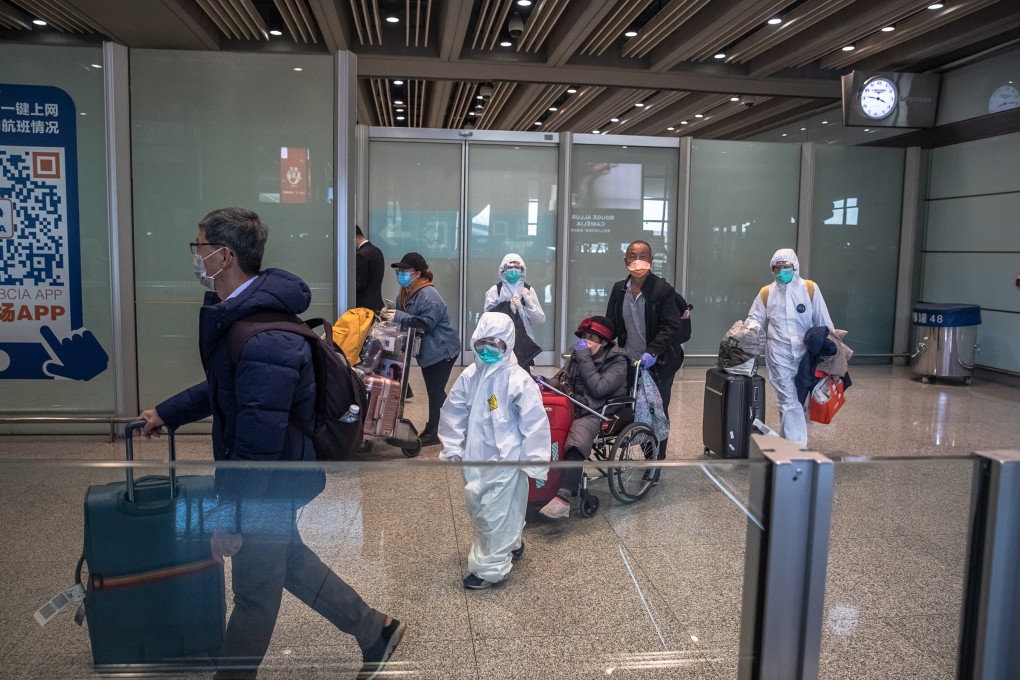 A family arrives in hazmat suits at Beijing Capital International Airport on March 4, 2020. Photo: EPA-EFE