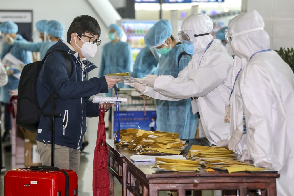 Airline staff at Wuhan airport distribute tickets to stranded Hong Kong residents. Photo: Handout