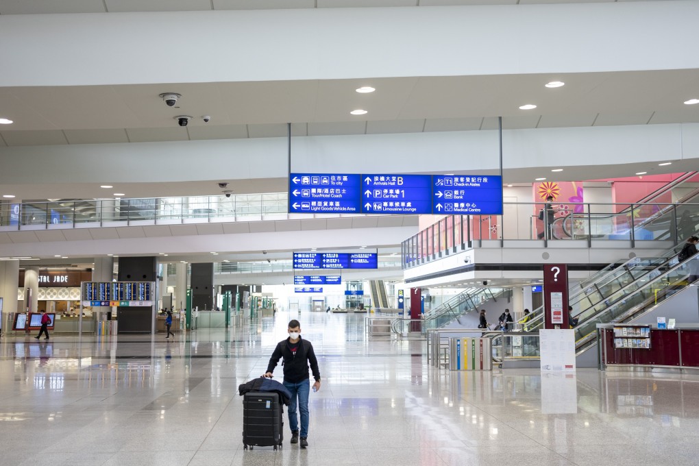 A traveller wearing a protective mask walks through the arrivals hall at Hong Kong International Airport. Photo: Bloomberg