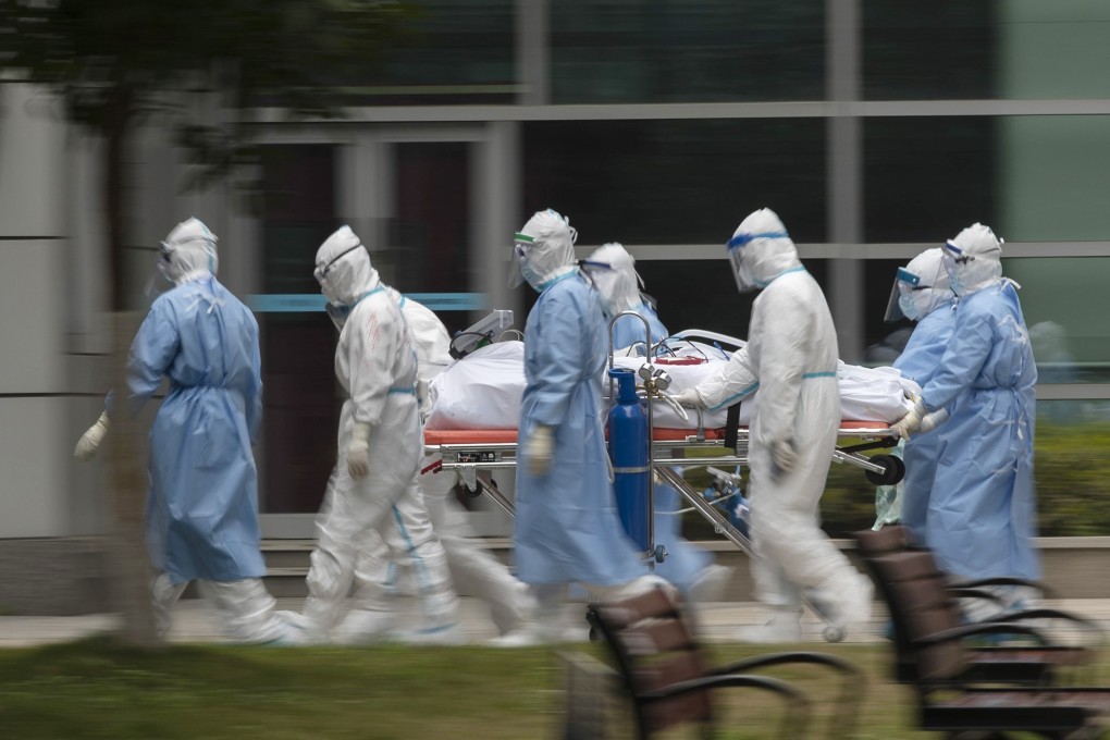 Medical workers transport a Covid-19 patient at a hospital in Wuhan, capital of central China's Hubei Province. Photo: Xinhua