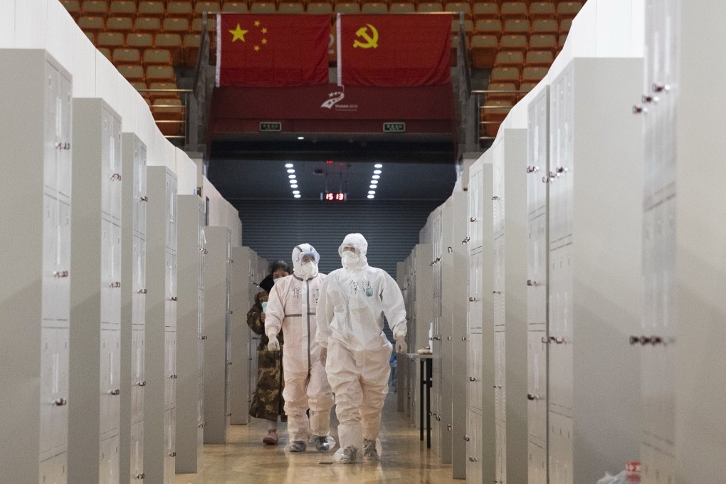 Medical staff check on patients in Wuhan Fangcang hospital, a makeshift facility to treat Covid-19 patients in Wuhan, capital of Hubei province and epicentre of the coronavirus outbreak, on February 14. Photo: EPA-EFE